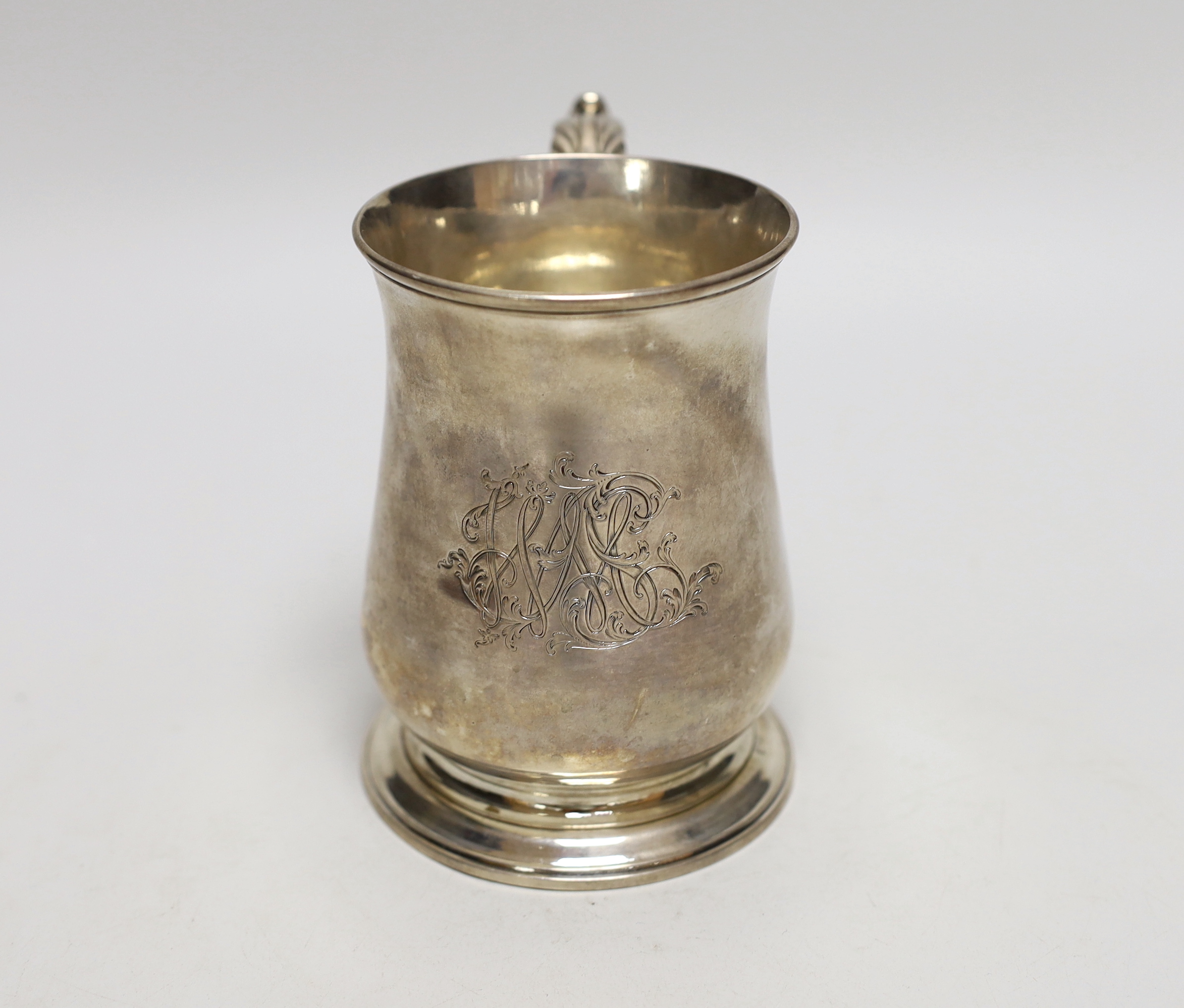 A George III silver baluster mug, with later monogram and acanthus scroll handle, makers initials FW, London 1775, 13cm, 372 grams